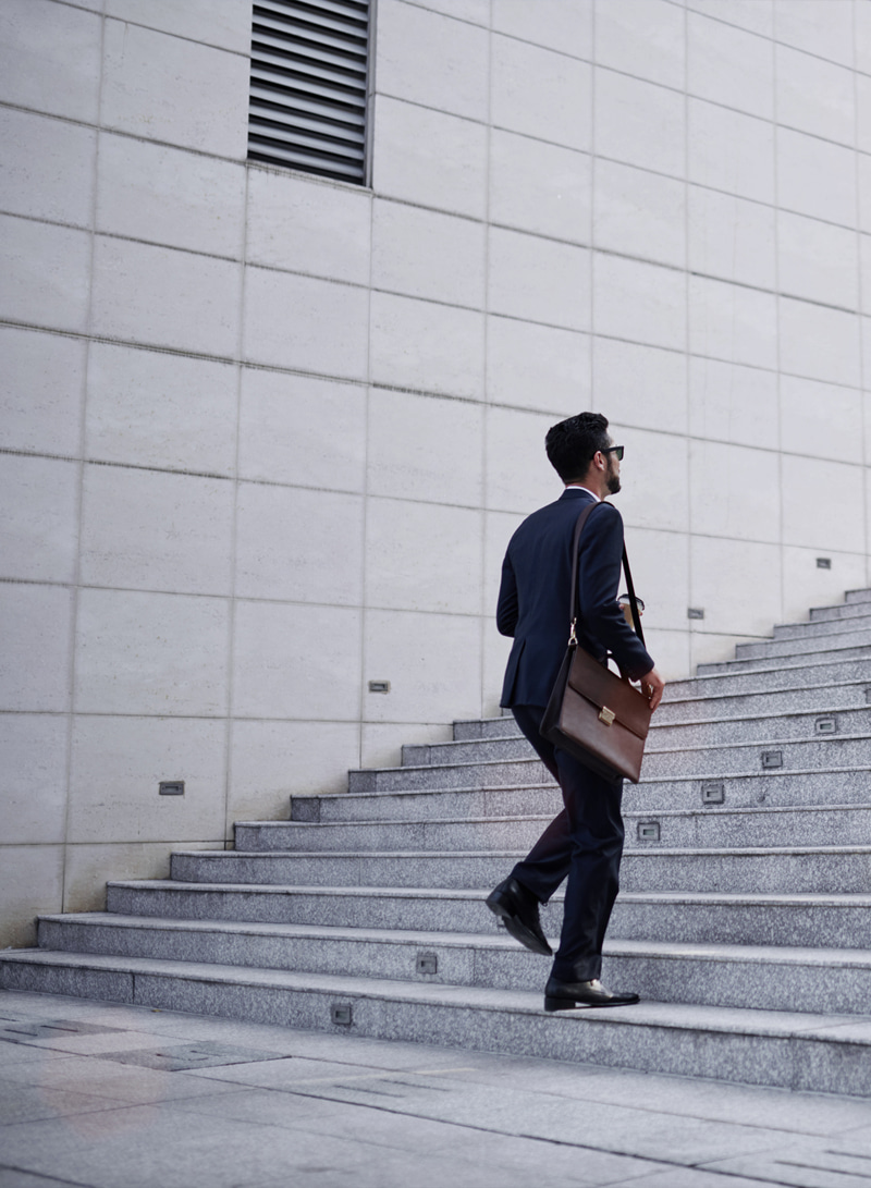 corporate_17 corporate business man walking up stairs